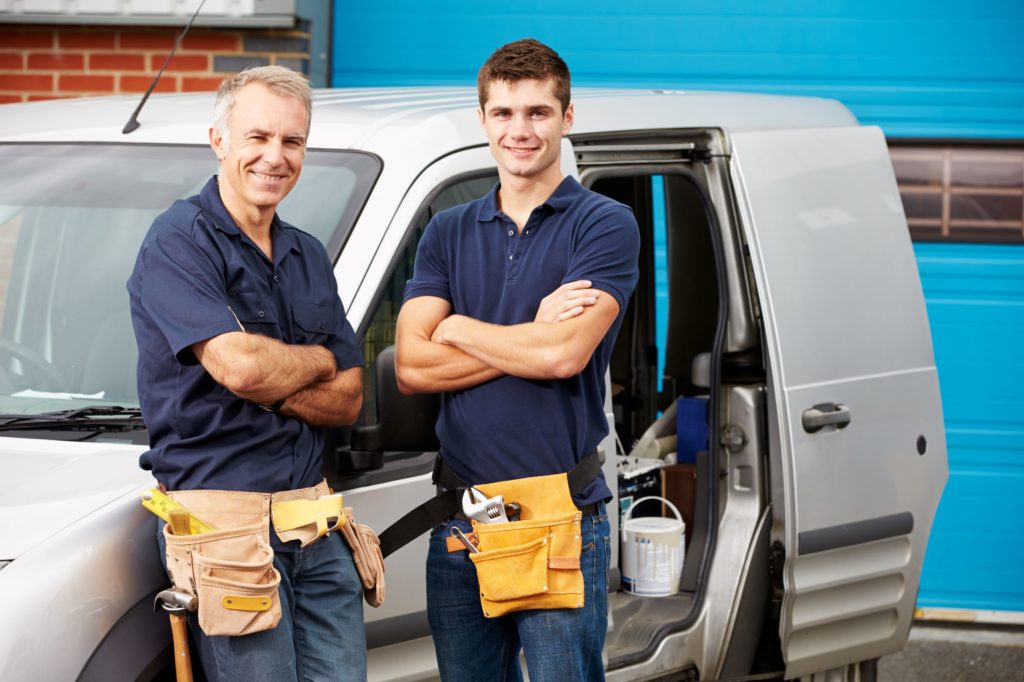 two tradies in front of their SUV