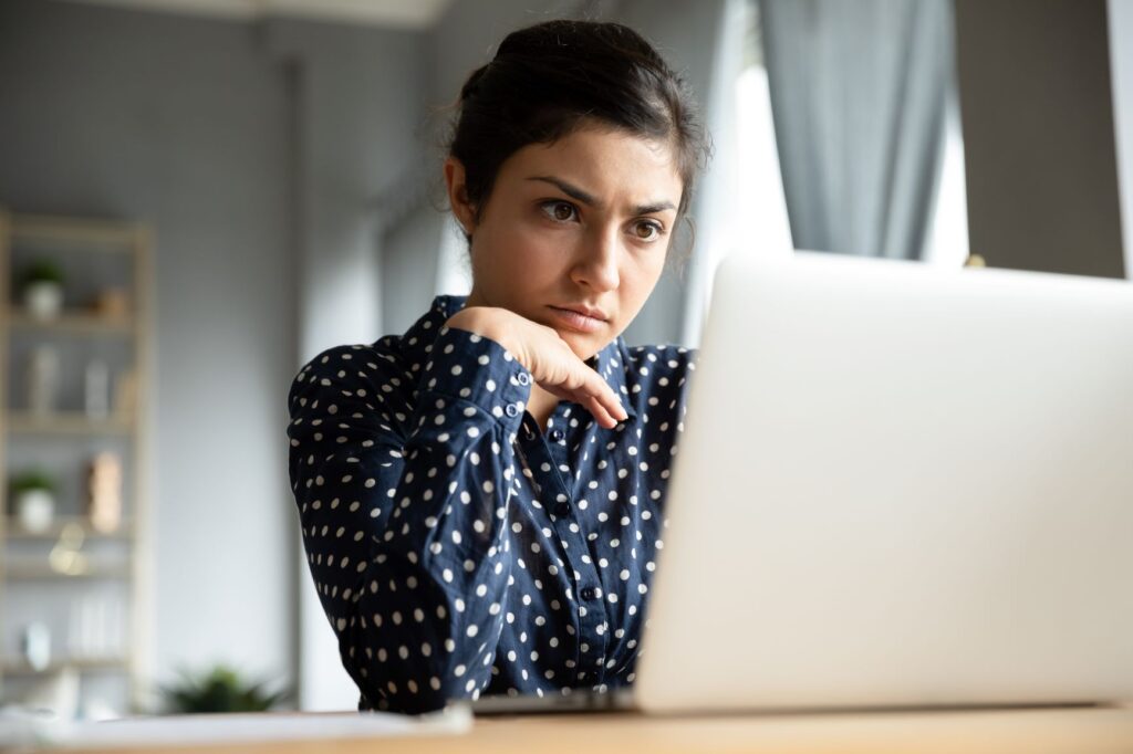 Woman looking perplexed at her computer.