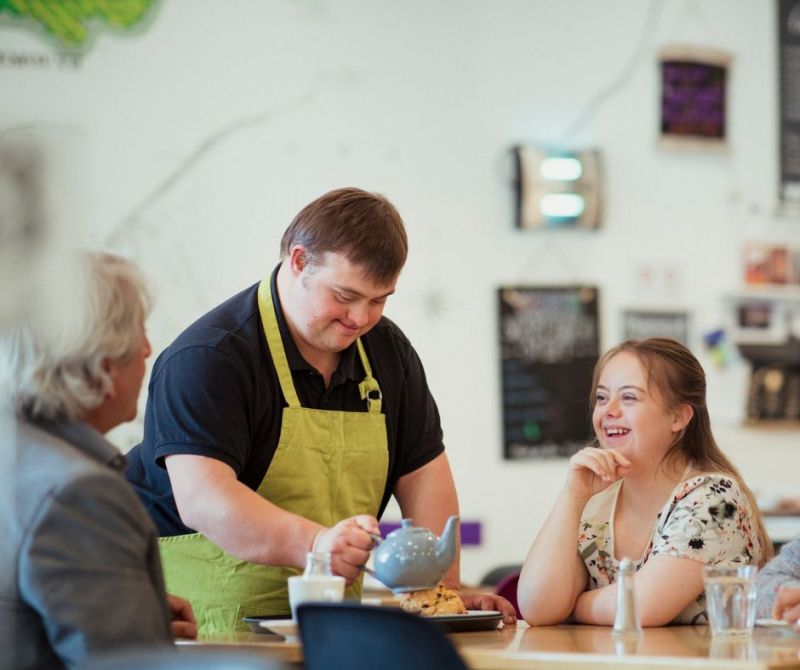 an image of a person with down syndrome serving customers