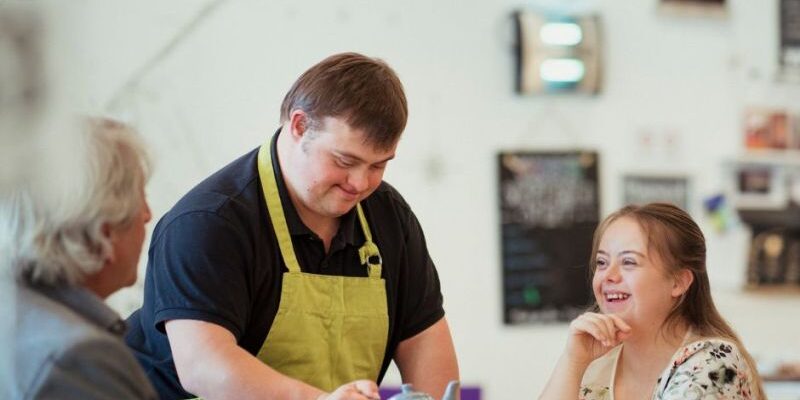 an image of a person with down syndrome serving customers