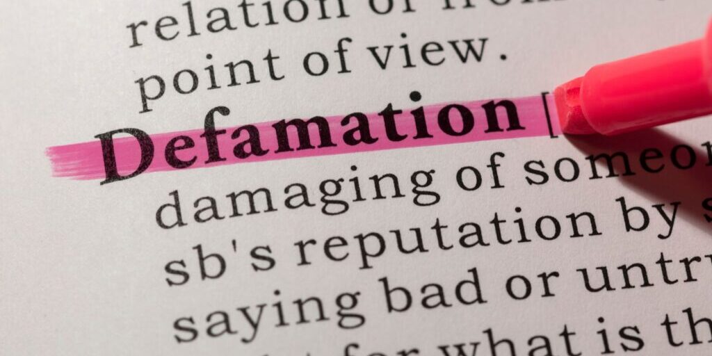 Dictionary with the word defamation highlighted