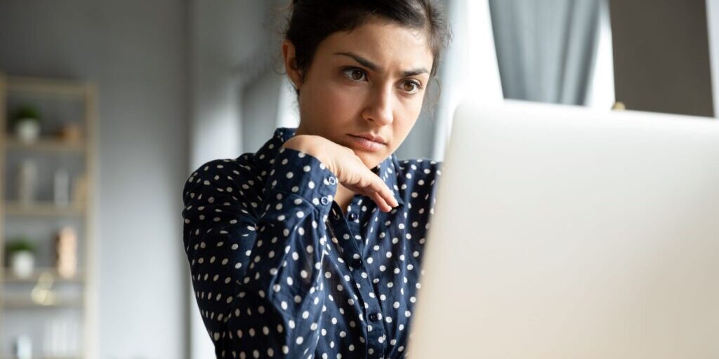 Woman looking perplexed at her computer.