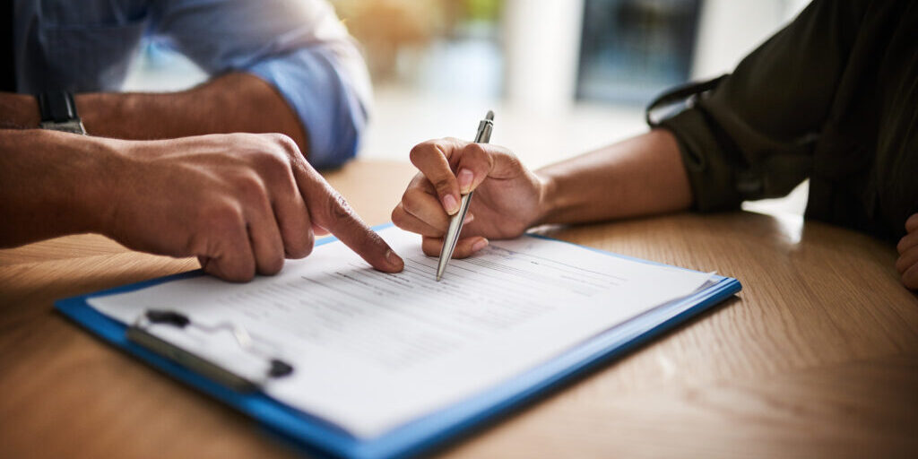 Lawyer, broker or HR manager signing a contract agreement with client or employee. Financial advisor asking for womans signature for insurance, legal paperwork or claim document.