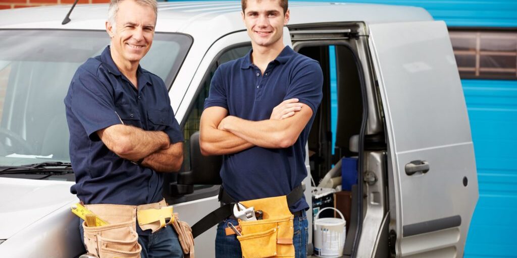 two tradies in front of their SUV